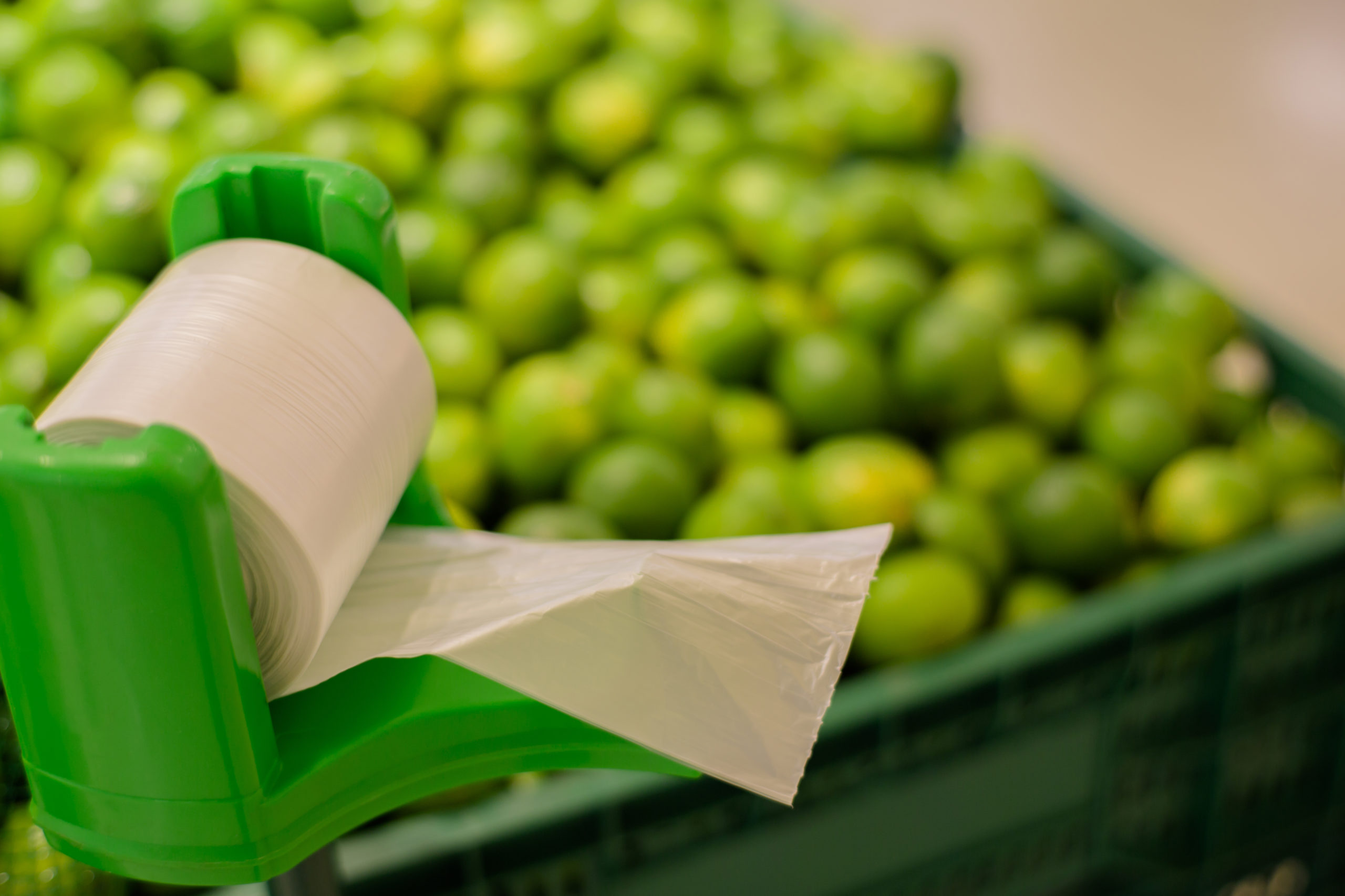 Grocery worker solves the problem of how to open a produce bag when wearing a mask